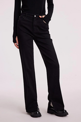 a lady in black straight leg jeans with black loafers